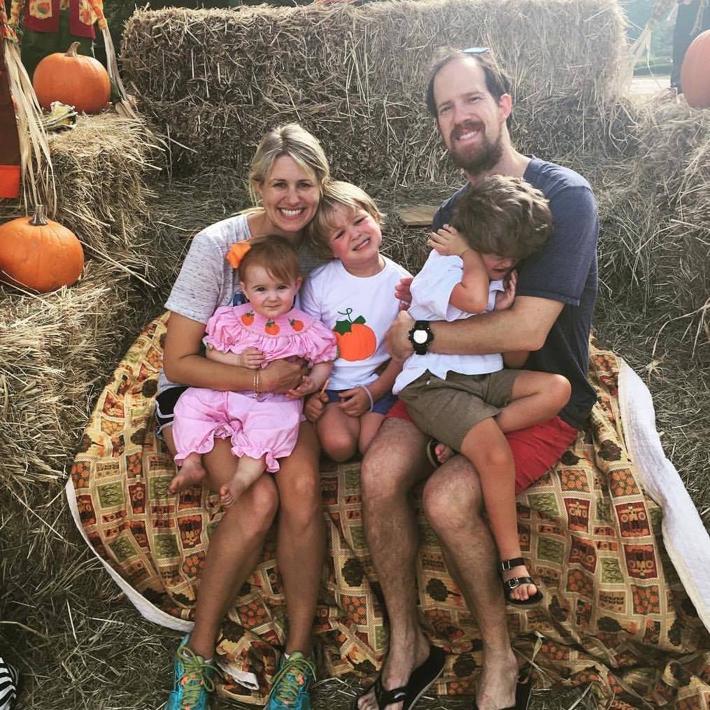 family in pumpkin patch in October