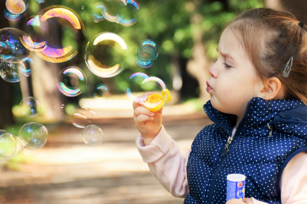 toddler blowing bubbles