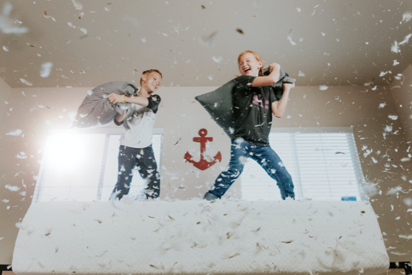 kids messing up their playroom by playing cooperation