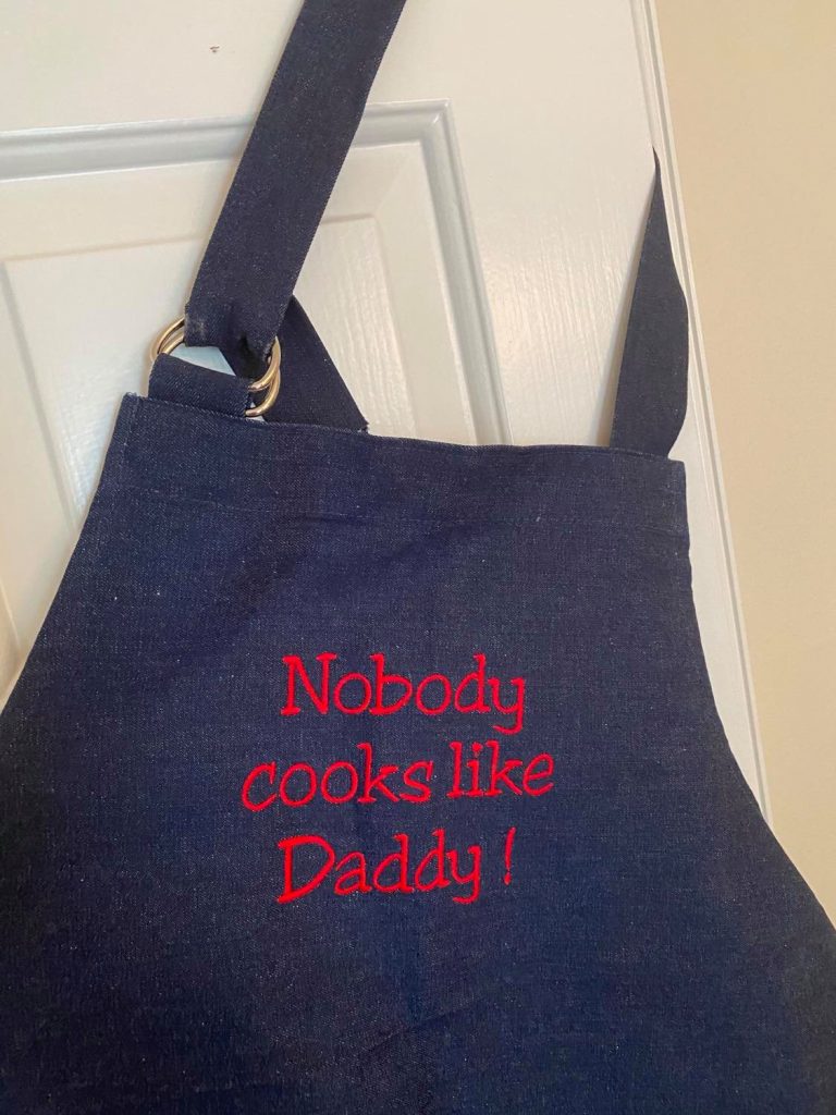 dad cooks dinner apron