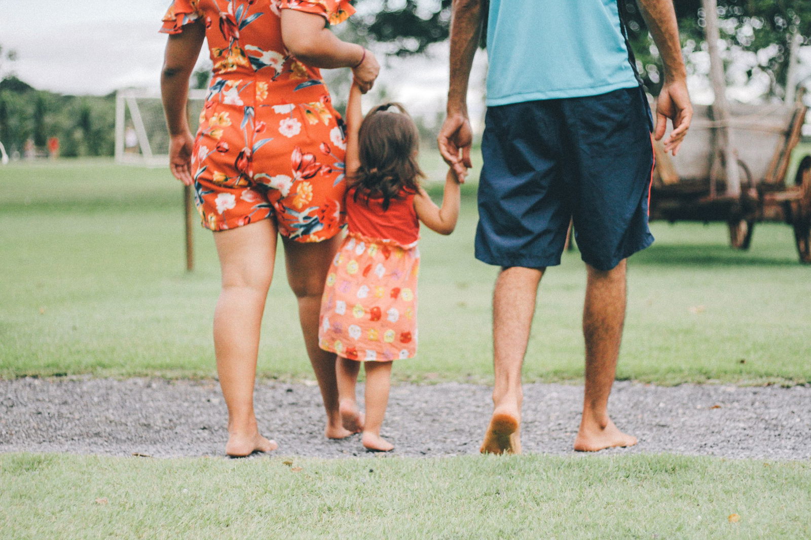 Family of three holding hands