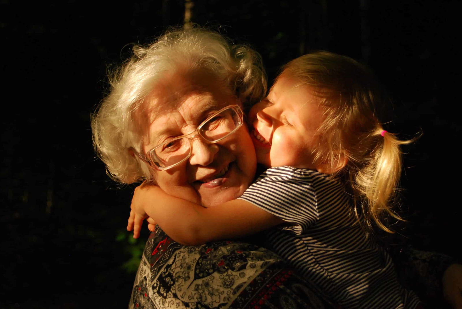 a girl giving her grandmother a hug and expressing her love language 