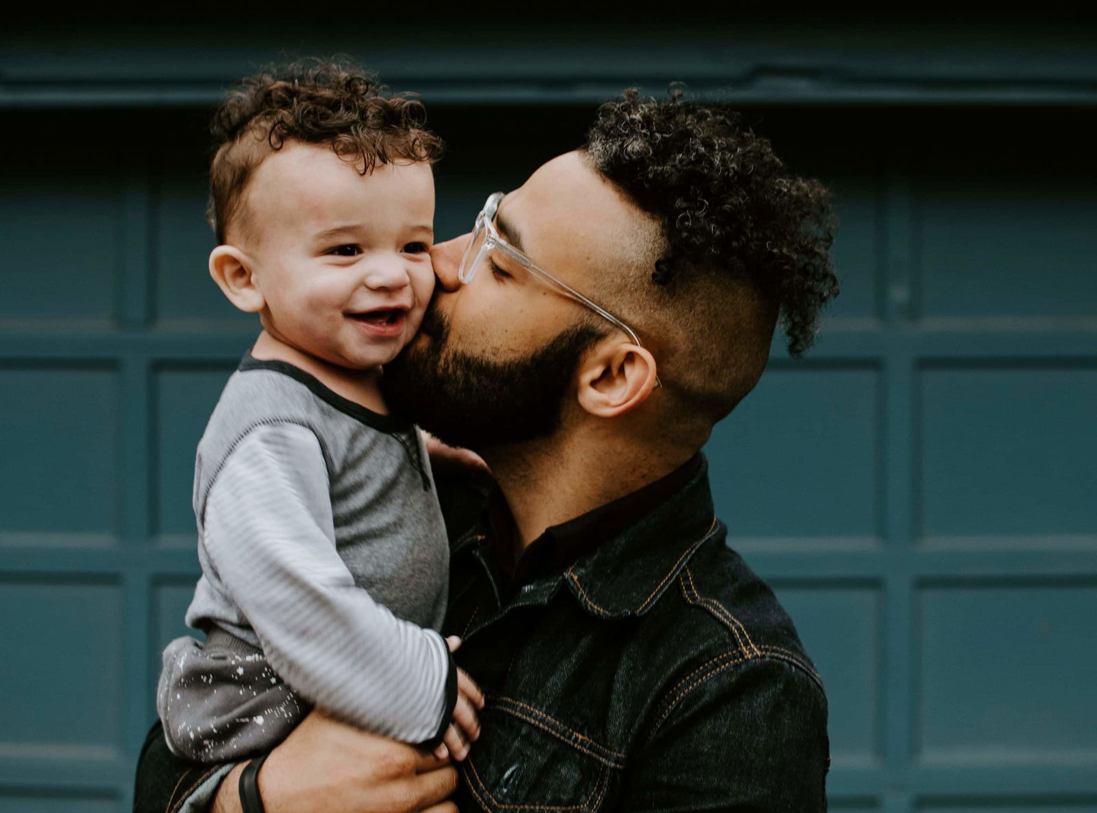 dad kissing son on the cheek, physical touch is his love language