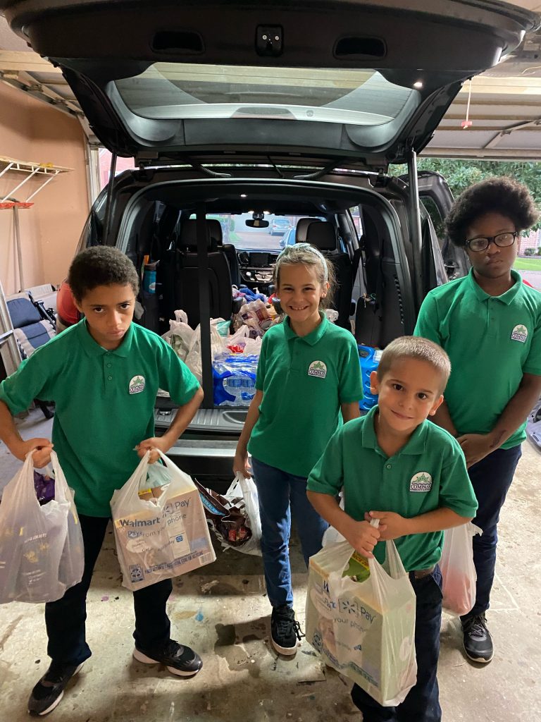 kids carrying the groceries inside