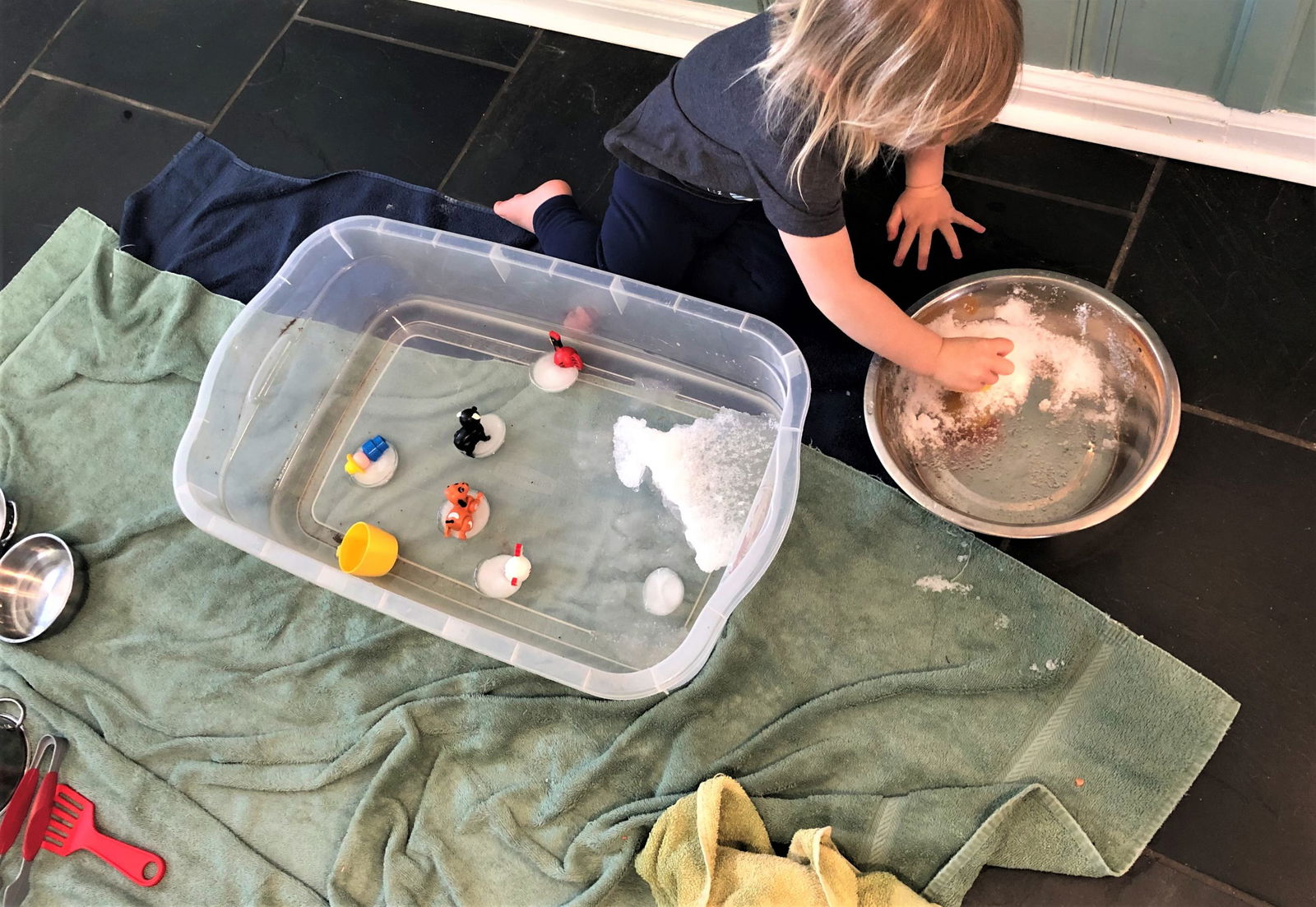 child playing with snow and ice