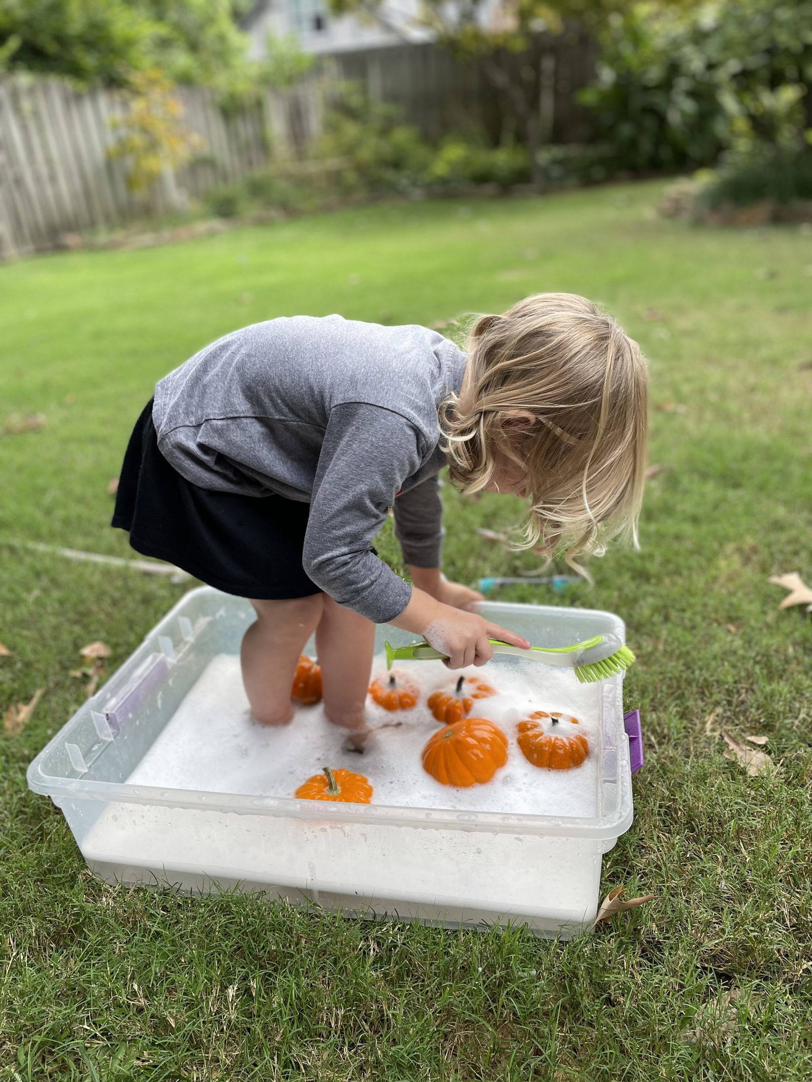 child cleaning pumpkins