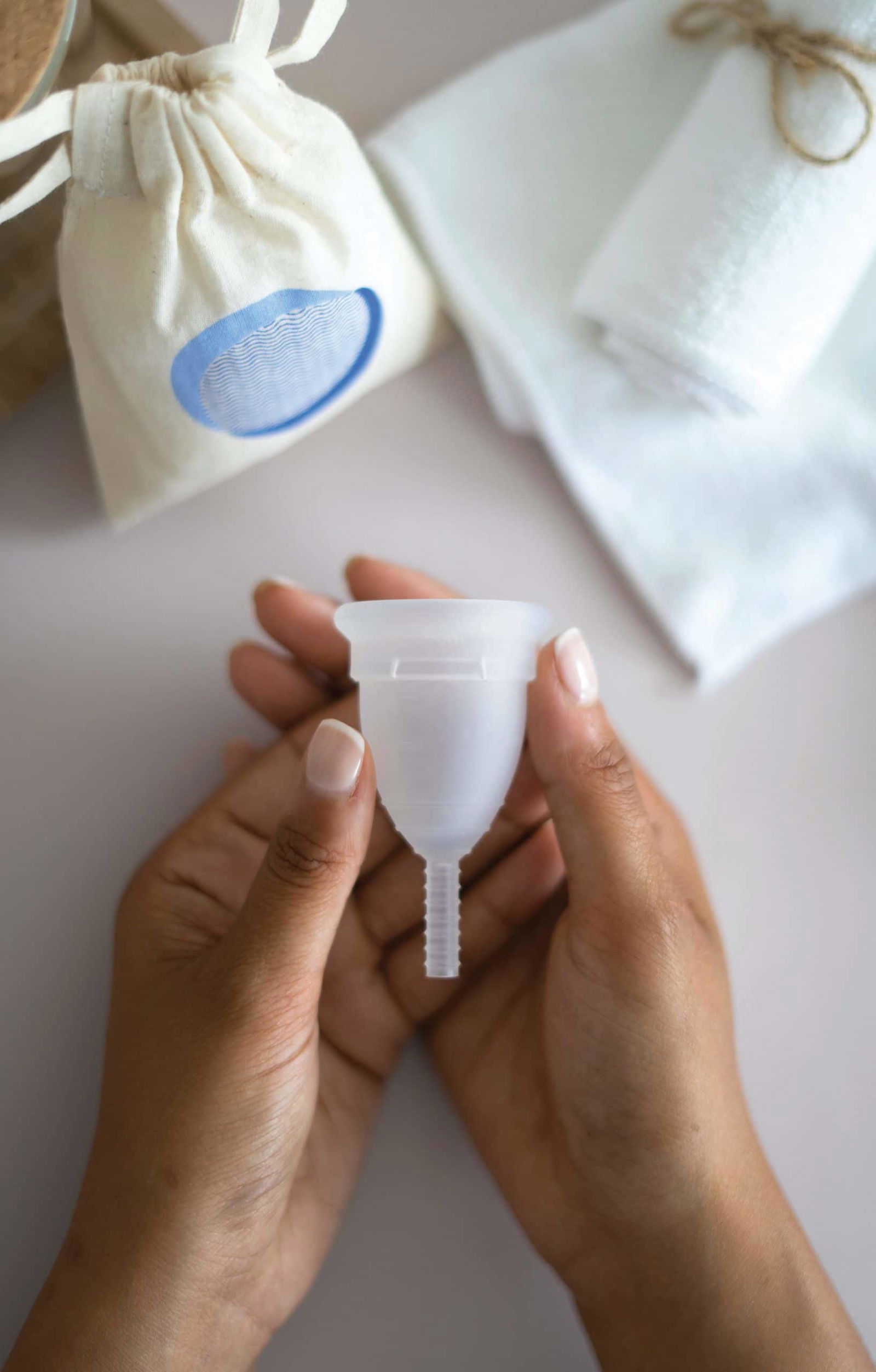 woman holding a menstrual cup