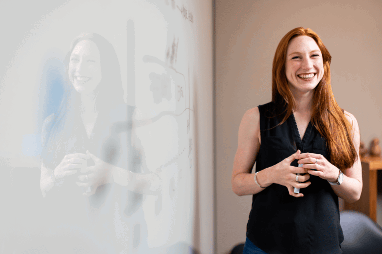 smiling teacher by the whiteboard