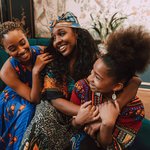 Three Black women celebrating Kwanzaa