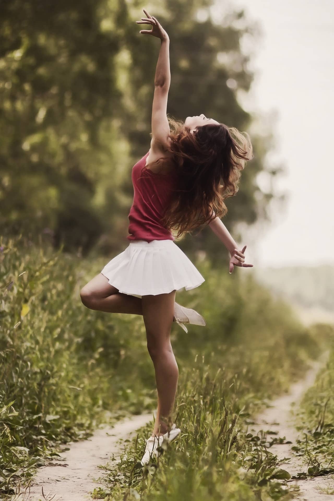 woman dancing in the grass