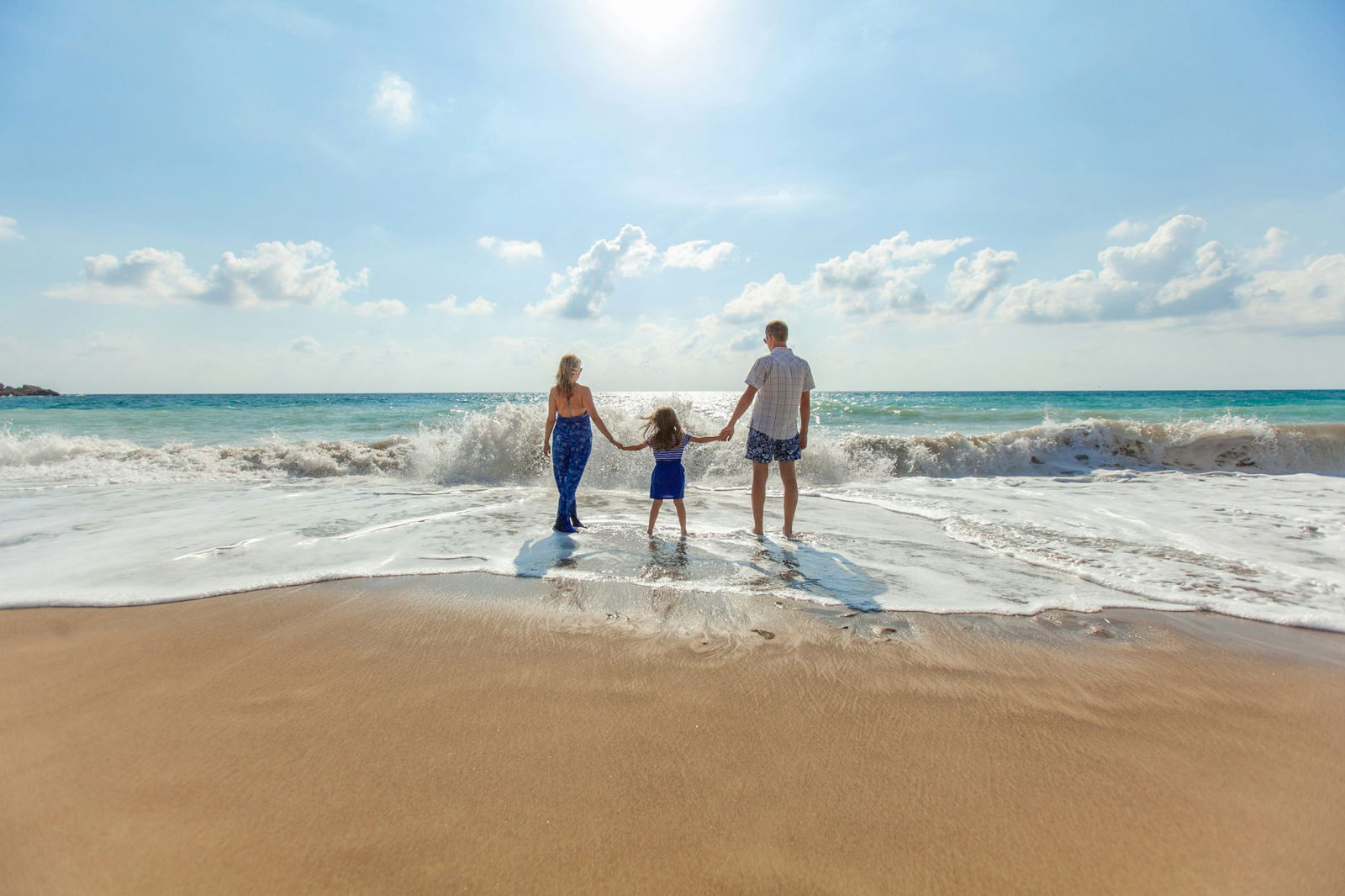 family on travel vacation at the beach