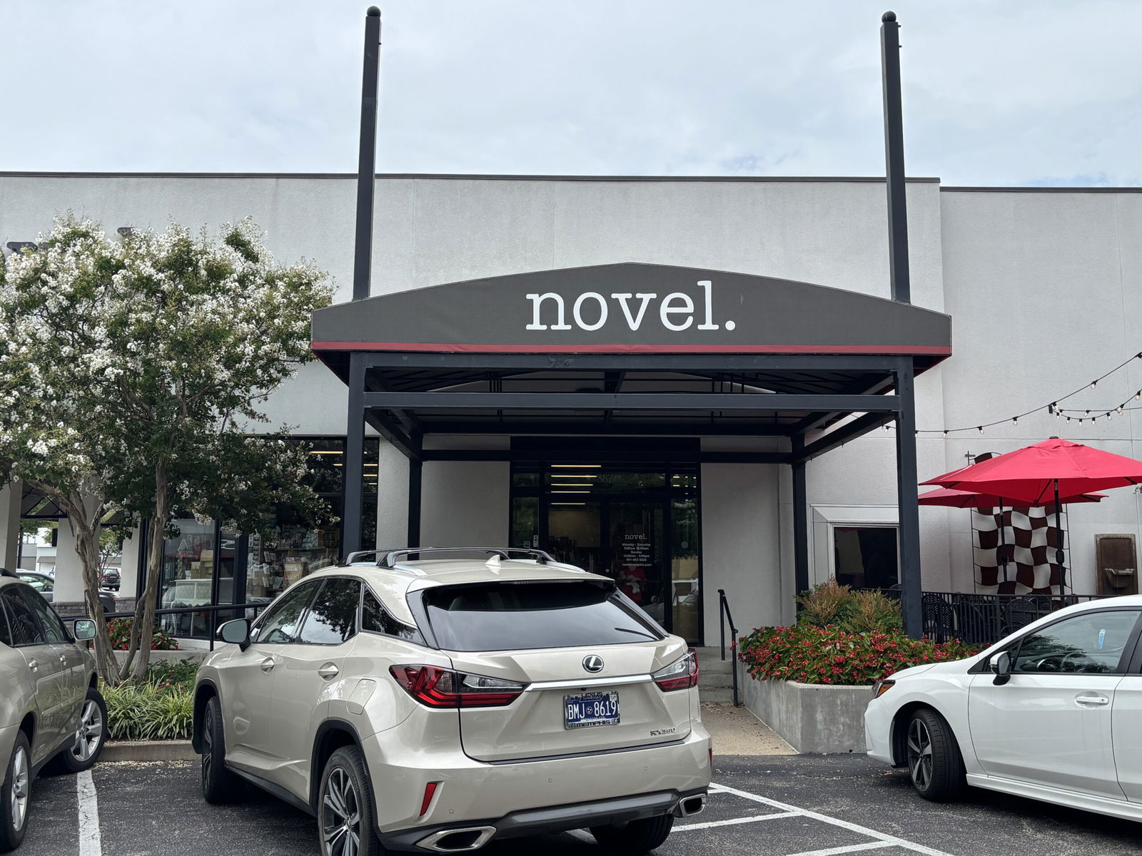 Novel awning at the entrance of the bookstore with a white care in front
